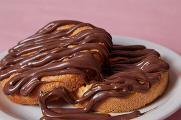 fresh pancake in a plate poured with chocolate paste, cream on buns, pancakes with chocolate
