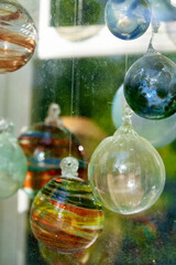 Multicolored glass balls in the window of a glass blowing workshop