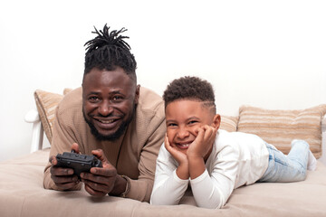 Waist up portrait of dark skinned  male and his little son spending time together, isolated