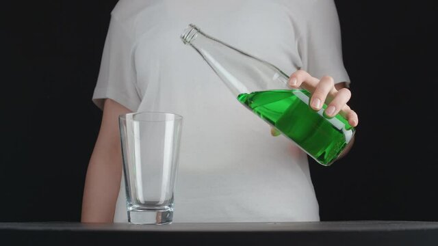 Shooting Of Young Woman Pouring Green Lemonade