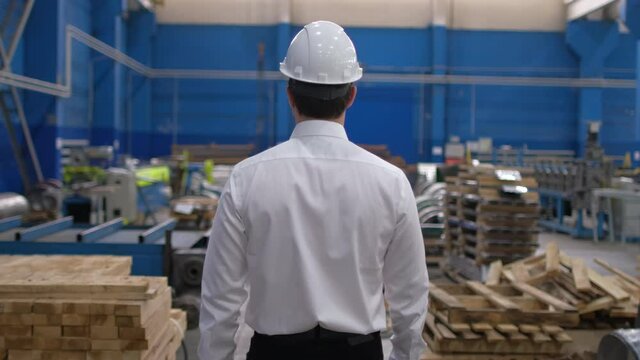 Follow footage of engineer man businessman business people in hard hat, engineering manufacture plant factory indoors, worker hardhat working on production line in modern manufacturing Industry