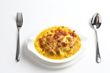 oven baked creamy cheese Japanese curry pasta with chicken in bowl western chef cuisine seafood menu in white and brown background