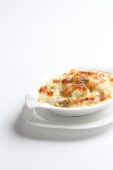 oven baked creamy cheese carbonara pasta with fresh big prawn in bowl western chef cuisine seafood menu in white and brown background