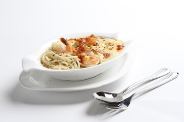 oven baked creamy cheese carbonara pasta with fresh big prawn in bowl western chef cuisine seafood menu in white and brown background