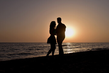 Young Couple on the Beach at Sunset
