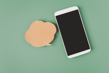white smart phone with clipping path on touchscreen , blank grunge brown speech bubble  paper on...