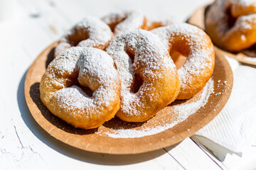 Dessert crumpet with powdered sugar on a cardboard plate