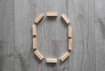 letter O natural wooden blocks on floor alphabet lettering