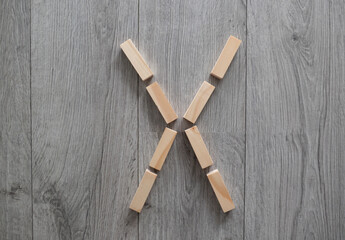 letter X natural wooden blocks on floor alphabet lettering