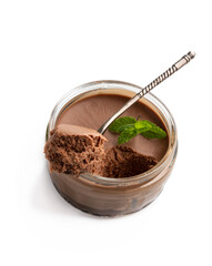 Mini caramel cheesecake in a glass pot with spoon isolated on white