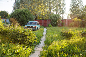 Blue car VAZ (Lada) 2014 in the courtyard of a country house