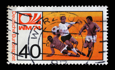 A stamp printed in Germany shows Midfielder, World Cup Soccer Championship in Germany, circa 1974 - obrazy, fototapety, plakaty
