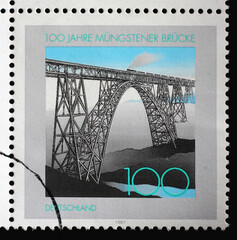 A stamp printed in Germany shows Train on Müngsten Railway Bridge, Centenary of Müngsten Railway...