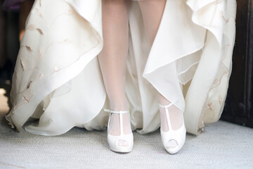 Bride with dress and shoes on her wedding day in medium flat