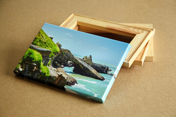 Photo canvas print stretched with gallery wrap and wooden stretcher bars on fiberboard table, landscape photo