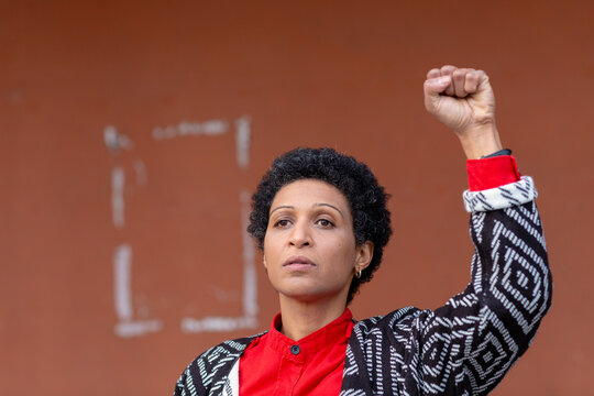 Italy, Tuscany, Pistoia, Woman raising fist