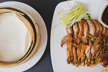 Sliced Beijing duck on ceramic plate