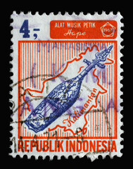 Stamp printed in Indonesia shows Hape musical instrument and Borneo island, Indonesian islands and...