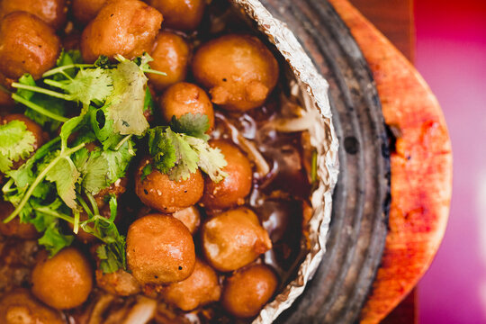 Taro roasted in foil on wooden table