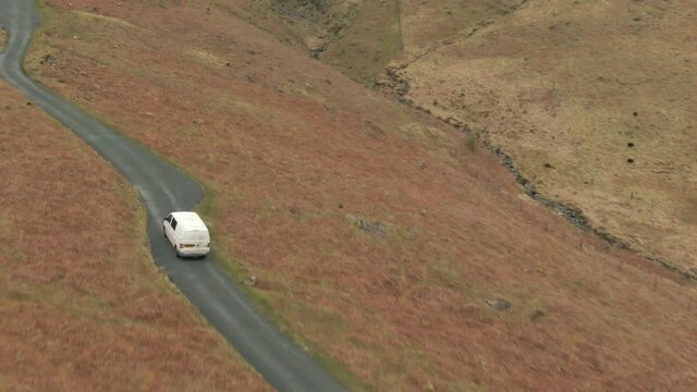 Mini van on road in Lake District National Park, Cumbria, UK