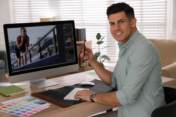 Obraz na płótnie Canvas Professional retoucher working on computer in office