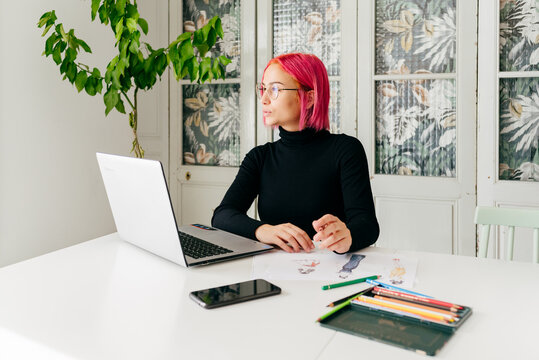 Pensive fashion designer working at home
