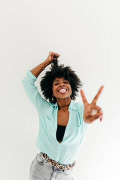 Cheerful woman showing peace sign
