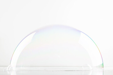 A hemisphere of a transparent soap bubble mockup for the presentation of cosmetics. White clean...