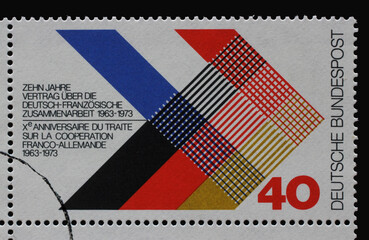 A stamp printed in Germany dedicated to the 10th Anniversary of the German-France Collaboration 1963-1973 intersecting flags of two countries, circa 1973.