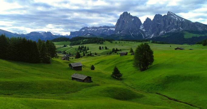 Aerial Shot Of Houses On Beautiful Green Landscape Against Sky, Drone Flying Forward Over Meadow - Seiser Alm, Italy