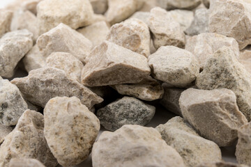 Gray small rocks ground texture isolated on white background. Small road stone.