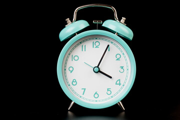 Old clock isolated on black background with space for text. Concept of time