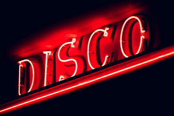 Illuminated red signboard of Disco