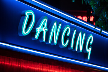 Fototapeta premium Neon glowing signboard of dancing