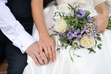 Couple with joined hands and wedding bands