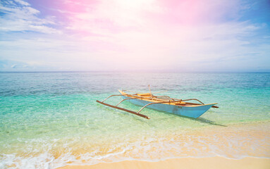 Landscape view of the beach, turquoise sea in summer, fishing boat