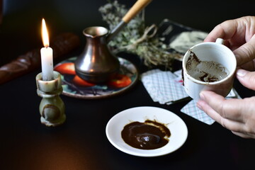 fortune telling on coffee grounds by candlelight