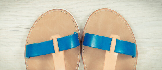 Pair of womanly leather sandals, footwear for holiday concept