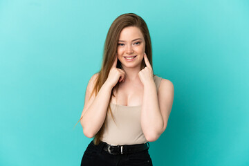 Teenager girl over isolated blue background smiling with a happy and pleasant expression