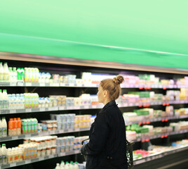 Woman choosing a dairy products at supermarket