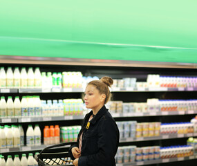 Woman choosing a dairy products at supermarket