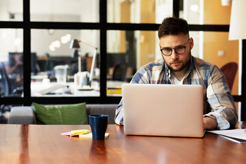 Businessman sitting looking at his laptop. Businessman working in the office on his laptop