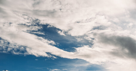 Fluffy white and gray clouds floating on blue sky