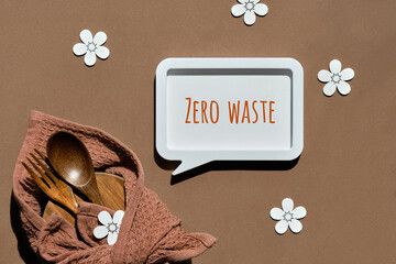 Packed lunch box set. Text Zero Waste in text bubble frame. Simple arrangement on brown paper...