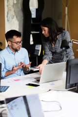 Colleagues in office. Businesswoman and businessman discussing work in office..