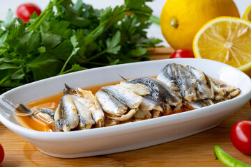 Marinated anchovies on wooden background. Seafood dishes. Local name soslu hamsi