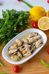 Marinated mussels on wooden background. Seafood dishes. local name marineli midye