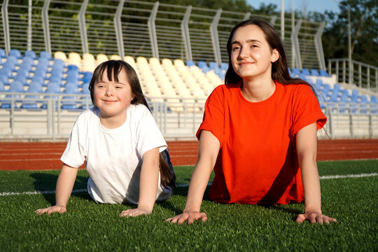 Little girl on the stadium with a coach