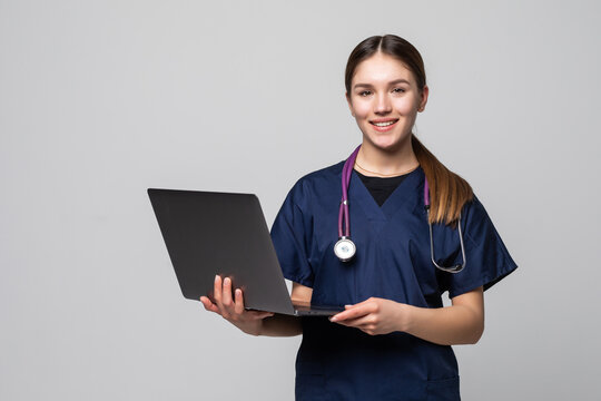 Beautiful Caucasian Woman Doctor Or Nurse Holding A Laptop Computer Isolated On A White Background