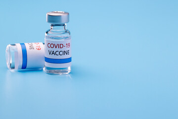 covid-19 vaccine bottle with blue background